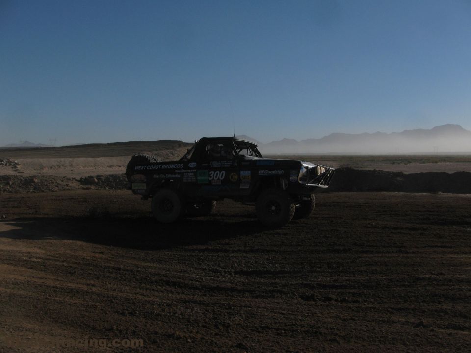 Number 300 West Coast Broncos race truck on a dusty desert course