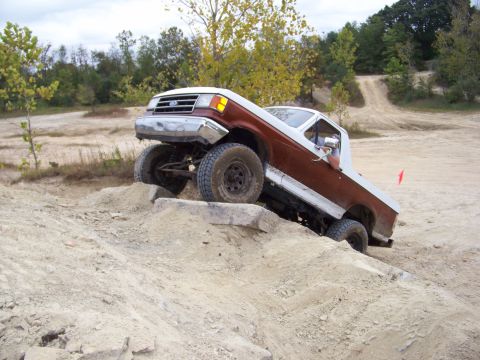 1989 Ford Bronco - This pickup truck navigates a rocky incline during an off-road event.