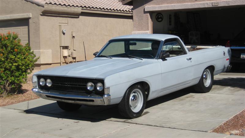 Light blue 1970 Ford Ranchero parked in driveway, front quarter view