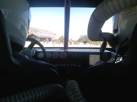 1989 Ford Bronco - View from inside a vehicle's cabin, showing the dashboard and a desert scene through the windshield.
