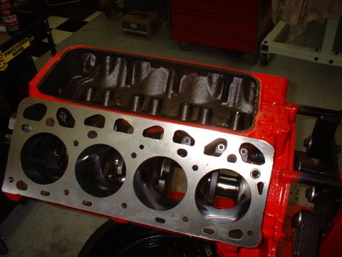 1955 Ford Thunderbird - Close-up view of a red engine block, showing the cylinder bores and gasket surface.