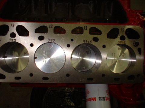 1955 Ford Thunderbird - Close-up view of an engine block's cylinder head, revealing pistons and stamped identification numbers.