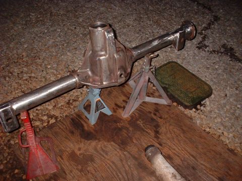 1955 Ford Thunderbird - A rear axle assembly is shown supported by jack stands on a wooden surface.