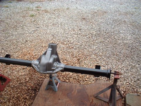 1955 Ford Thunderbird - Rear axle assembly supported by jack stands on a wooden surface.