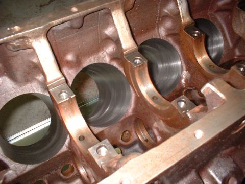 1967 Ford Mustang - Close-up view of an engine block's crankshaft bearing saddles and cylinder bores, showing internal engine components.