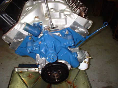 1967 Ford Mustang - Close-up view of a rebuilt engine blue painted components and an Edelbrock valve cover.