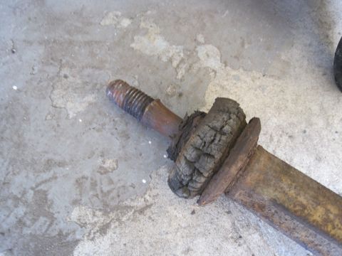 1979 Ford Bronco - Close-up of a rusted suspension component a severely degraded rubber bushing.