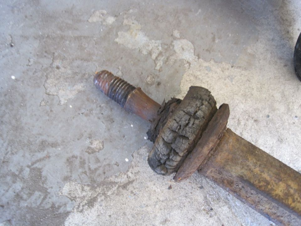 Rusted suspension part with cracked rubber bushing