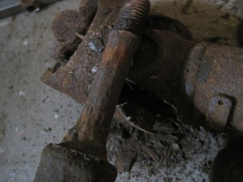 1979 Ford Bronco - This heavily corroded metal part appears to be a suspension component, possibly from an older vehicle.