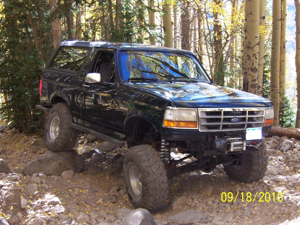 Dark green 1994 Ford Bronco on rocky trail