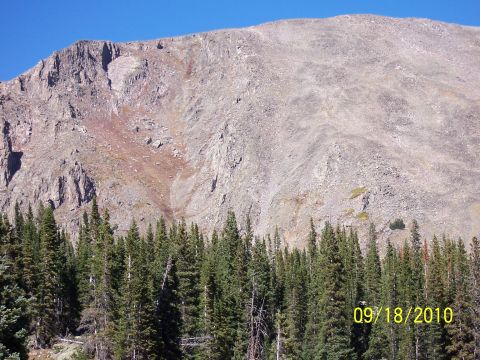 1994 Ford Bronco - A mountain landscape with a dense forest of pine trees in the foreground, dated 09/18/2010.