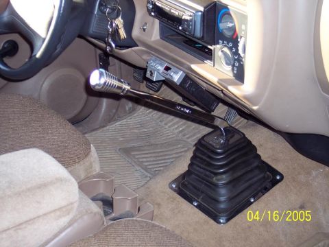1986 Ford Bronco - The interior of this vehicle features a chrome shifter, a CB radio mounted below the dash, and an aftermarket stereo system.