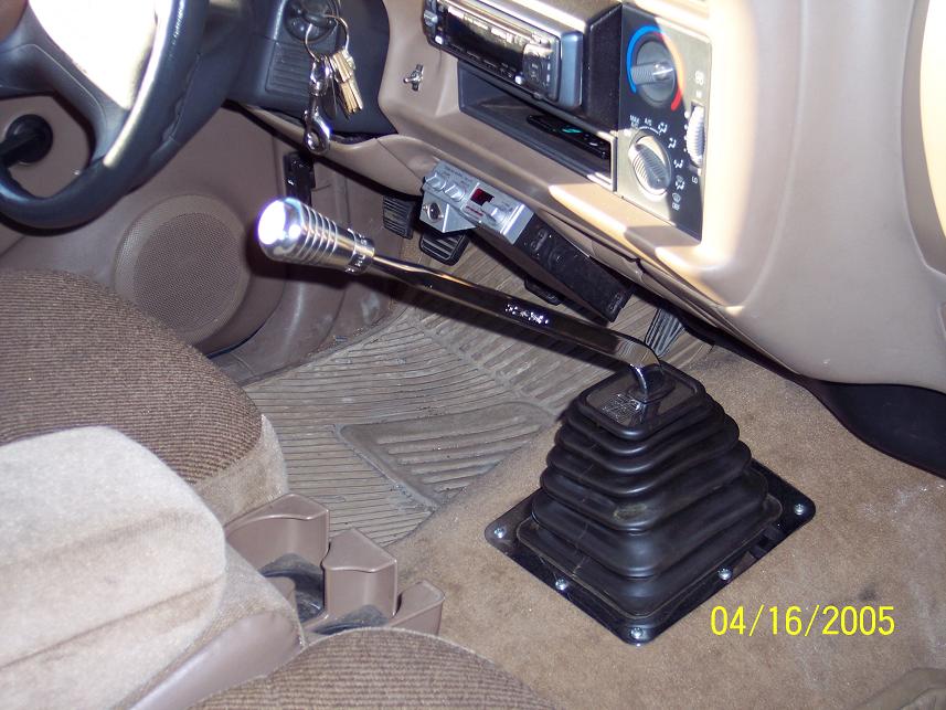 Interior view of a vehicle with a chrome shifter, CB radio, and aftermarket stereo