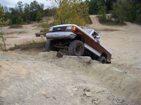 1989 Ford Bronco - This lifted Ford Bronco navigates a rocky obstacle course on a dirt trail.