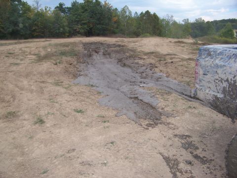 1989 Ford Bronco - A vehicle navigates a muddy off-road course, leaving tracks in the dirt.