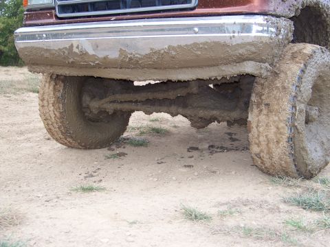 1989 Ford Bronco - This vehicle's front axle and tires are heavily caked in mud, suggesting off-road use.