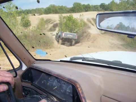 1989 Ford Bronco - A driver's perspective from inside a dusty 1980s Ford Bronco as another vehicle navigates an off-road trail.