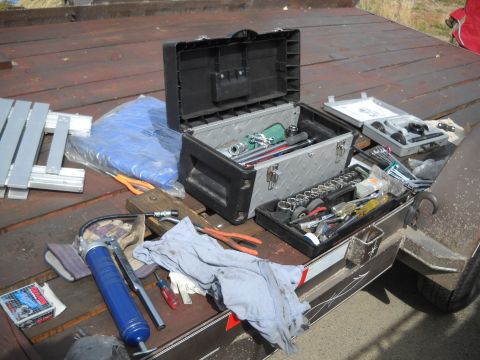1986 Ford Bronco II - Various tools and toolboxes are laid out on a trailer, ready for use.