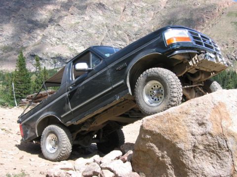 1995 Ford Bronco - This 1995 Ford Bronco navigates a rocky mountain path, demonstrating its off-road capabilities.