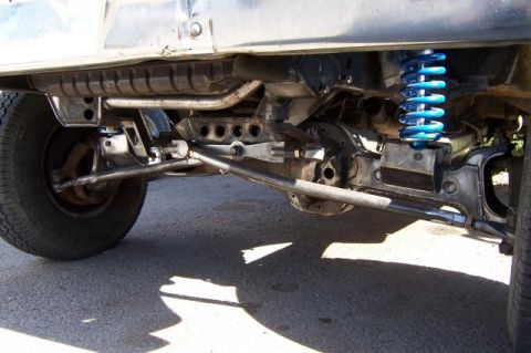 1986 Ford Bronco - Custom suspension and drivetrain components, including a Dana 50 axle and blue coilover shock, are visible on this vehicle.