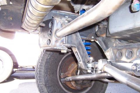 1986 Ford Bronco - Custom suspension parts are visible, with blue coil springs and fabricated metal brackets.