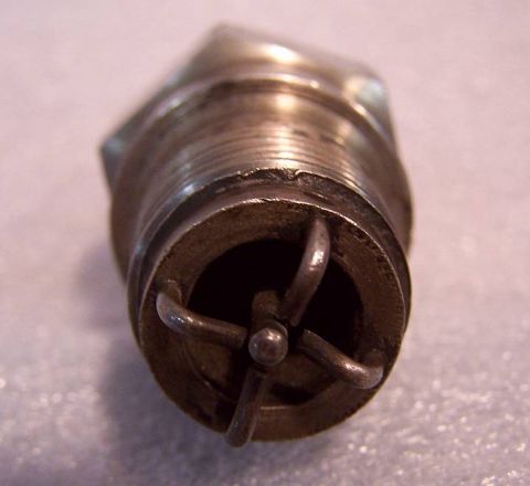1915 Ford Model T - Close-up view of a vintage spark plug, showing its internal electrode structure.