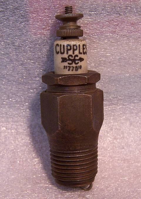 1915 Ford Model T - A close-up view of a vintage spark plug, identified by the markings 'CUPPLES SC "778"'.