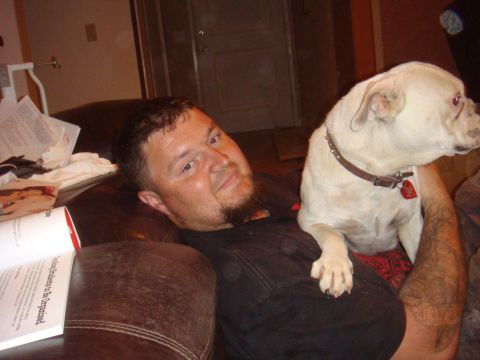 1992 Ford Bronco - Man and his dog relax on a couch indoors.