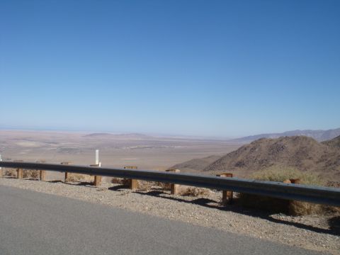 1992 Ford Bronco - A vast desert landscape stretches out under a clear blue sky, viewed from a scenic overlook.