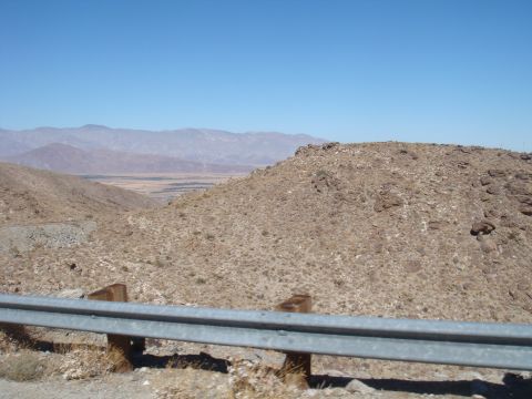 1992 Ford Bronco - A wide view of a desert landscape with mountains in the distance, under a clear blue sky.