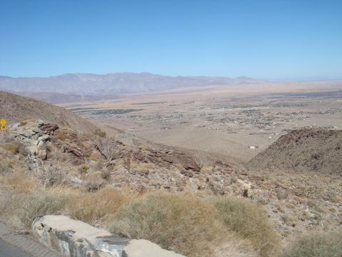 1992 Ford Bronco - A wide view of a desert valley with mountains in the background and a small town visible in the distance.