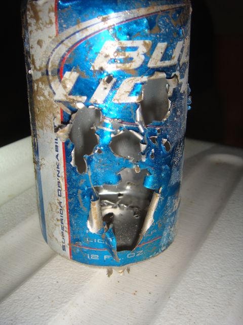 1992 Ford Bronco - A damaged Bud Light can, showing significant wear and tear, is pictured up close.