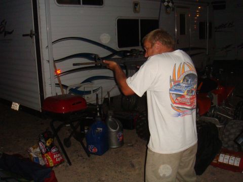 1992 Ford Bronco - Man works on something near a trailer, with an ATV in the background.