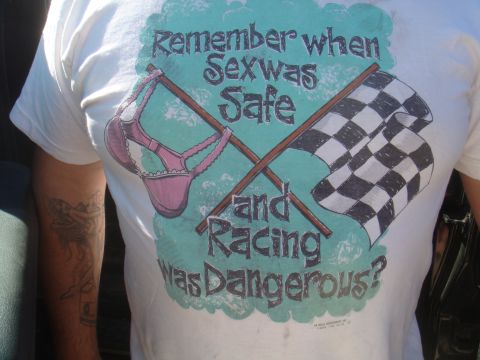 1992 Ford Bronco - A t-shirt graphic features a pink bra and checkered flags with text about sex and racing.