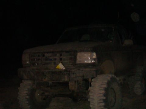 1992 Ford Bronco - This 1992 Ford Bronco is heavily covered in mud, obscuring most details but its iconic front end is still recognizable.