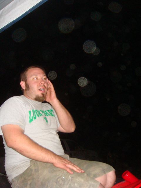 1992 Ford Bronco - A man sits in the interior of a vehicle at night, with blurry lights visible in the background.