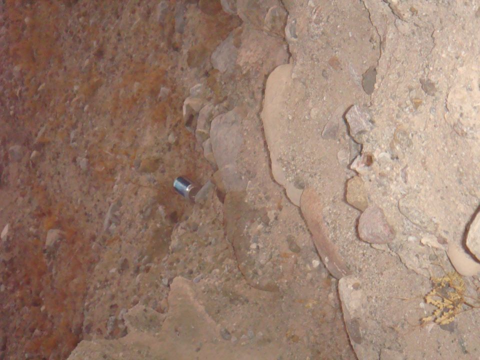 Rocky ground with a silver can lying on its side