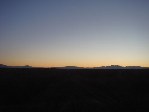 1992 Ford Bronco - Desert landscape at dusk with mountains on the horizon and a Supermotors.net logo.