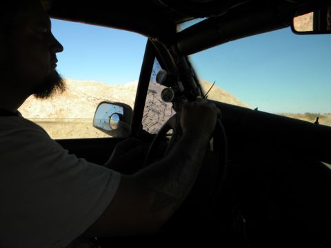 1992 Ford Bronco - Driver's perspective from inside a vehicle with a roll cage, navigating a desert landscape.