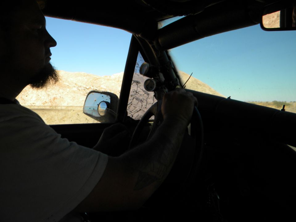 Interior view of driver in a modified vehicle with roll cage