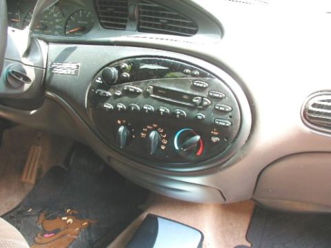 1997 Ford Taurus - Interior view of a 1997 Ford Taurus dashboard, showing the center console with radio and climate controls.