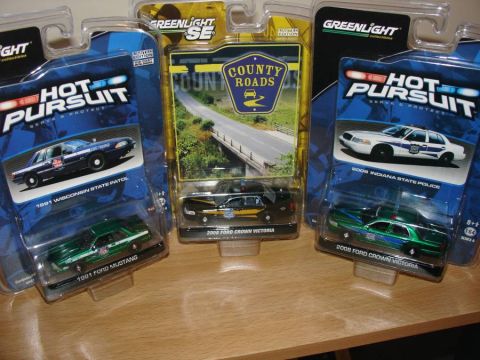 2003 Ford Crown Victoria - Collection of Greenlight Hot Pursuit die-cast police car models in their original packaging.