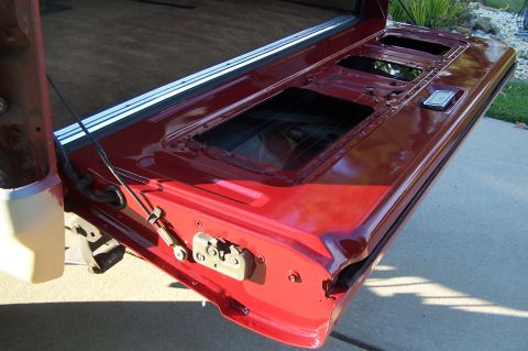 1990 Ford Bronco - Tailgate removed from vehicle, showing internal structure and latch.