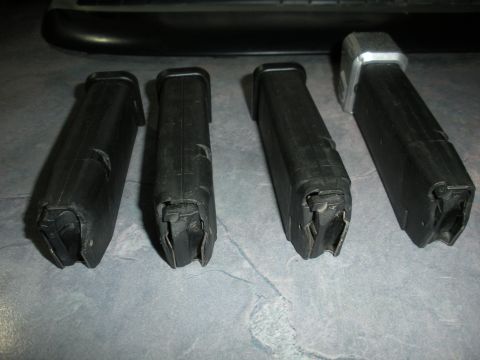 1996 Ford Bronco - Four pistol magazines are displayed on a textured surface, with a website watermark at the bottom right.