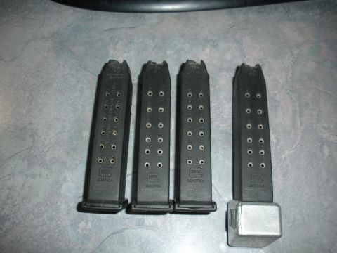 1996 Ford Bronco - Four Glock magazines are laid out on a textured surface, with text visible on each.