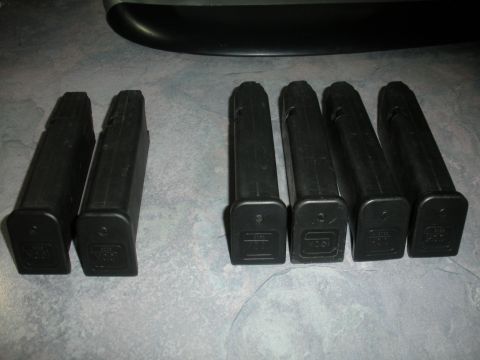 1996 Ford Bronco - Several black pistol magazines are laid out on a textured surface.