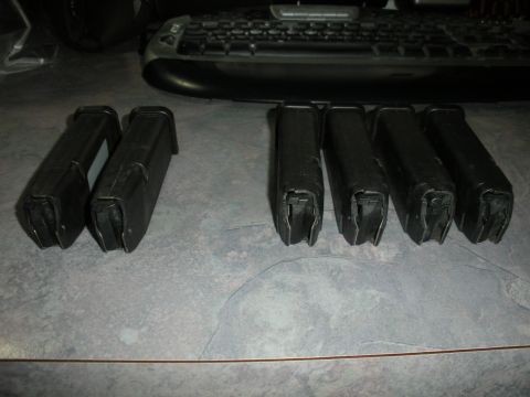 1996 Ford Bronco - Six black gun magazines are displayed on a textured surface next to a computer keyboard.
