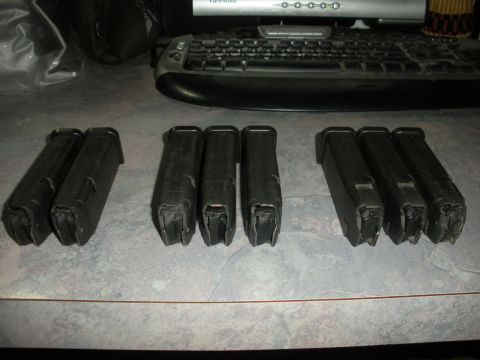 1996 Ford Bronco - Multiple firearm magazines are arranged on a textured surface, with a computer keyboard and monitor in the background.