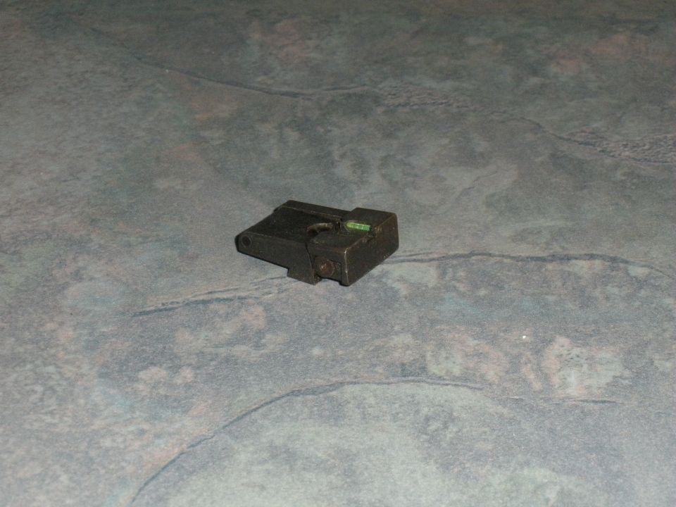 black gun sight with green insert