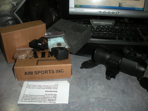 1996 Ford Bronco - Aim Sports Inc. rifle scope and red dot sight are laid out with their packaging and instructions.